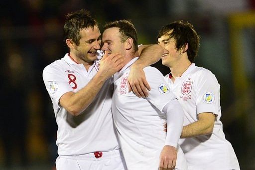 England's Wayne Rooney (C) celebrates with Frank Lampard during the 8-0 victory over San Marino on March 22, 2013